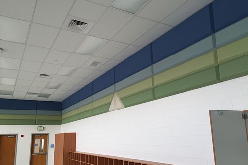 MBI Products Colorsonix blue and green acoustic wall panels installed in a classroom to control noise and make an environment better suited to learning